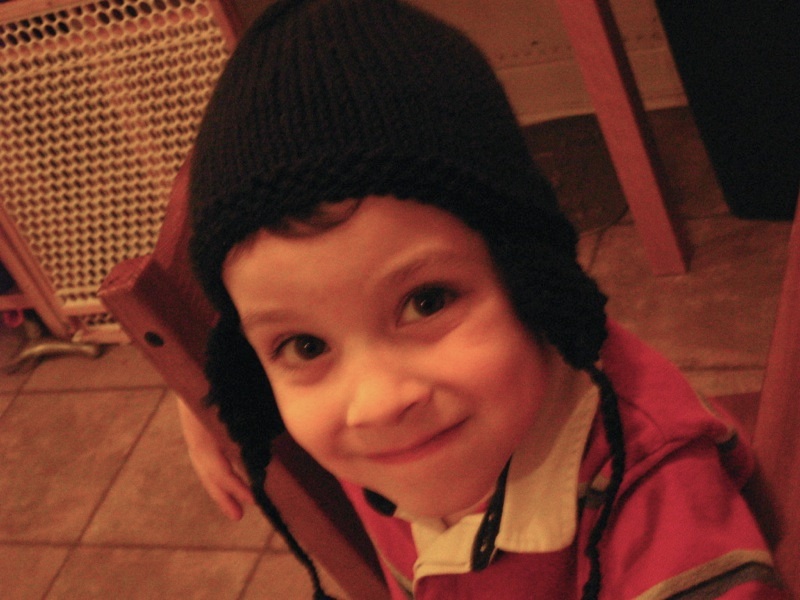 The boy hams it up while he shows off his new hat, 14 October 2009